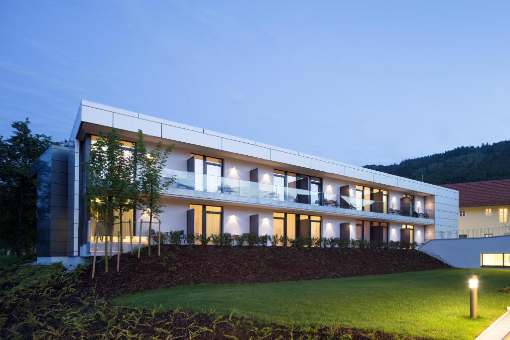 a large white building with lights on at night at Wesenufer Hotel & Seminarkultur an der Donau in Wesenufer