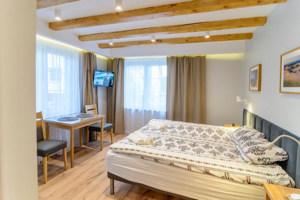Postel nebo postele na pokoji v ubytování Pensjonat Srebrny Klon