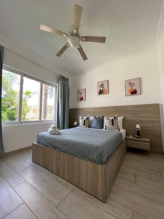 a bedroom with a bed with a ceiling fan at Casa Mulata Coral Village Pool & Playa in Punta Cana