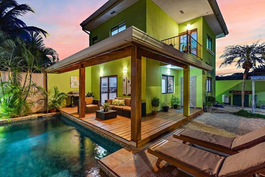 a house with a swimming pool in front of a house at Casa Mojito~Serene 2 bedroom with prime location! in Tamarindo