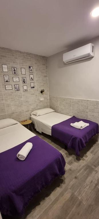 Postel nebo postele na pokoji v ubytování Hostal La Cabaña
