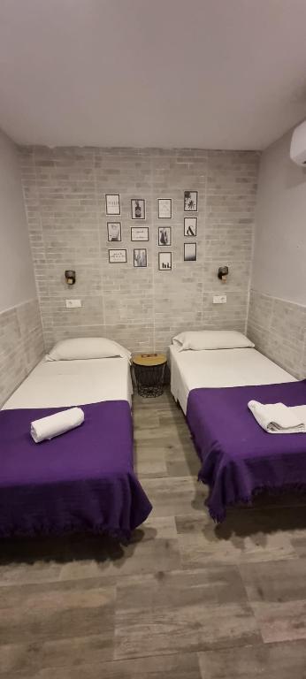 Postel nebo postele na pokoji v ubytování Hostal La Cabaña