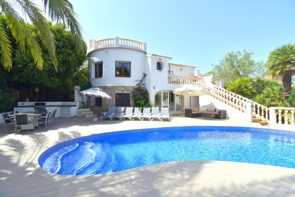 a villa with a swimming pool in front of a house at Casa la Selva Javea - 5043 in Jávea