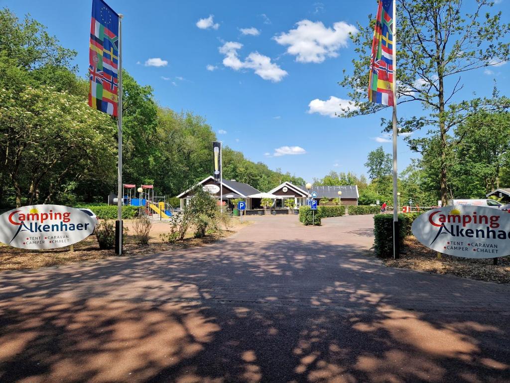 a playground with flags in the middle of a road at Camping Alkenhaer Appelscha Lege Kampeerplaats met Prive Sanitair in Appelscha