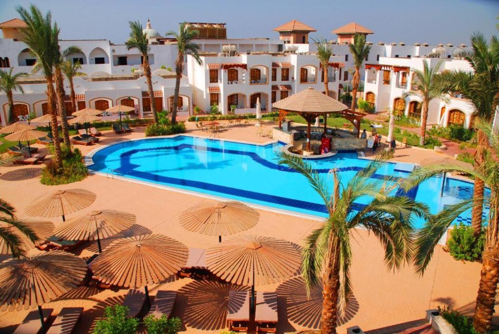 an aerial view of a resort pool with umbrellas at Sharm al-Sheikh, Egypt - Hotel Apartment in Sharm El Sheikh
