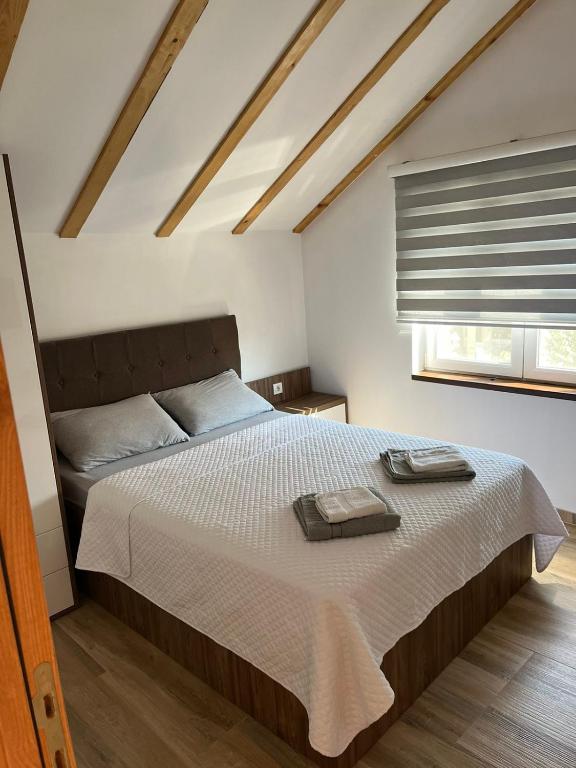 a bedroom with a bed with two towels on it at Zanes Guest House in Kladovo