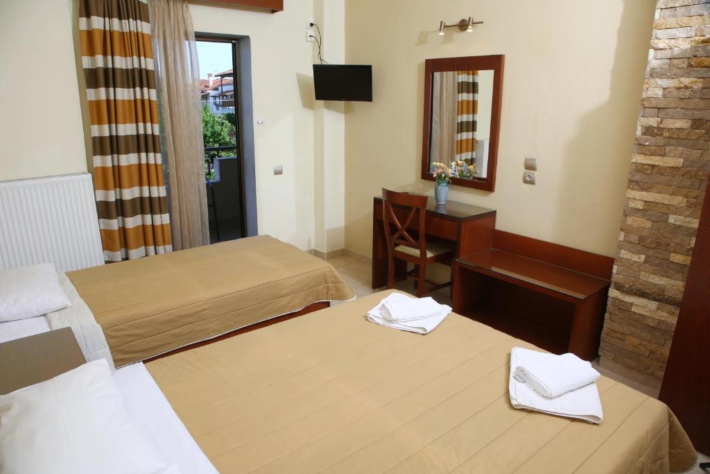 Postel nebo postele na pokoji v ubytování Hotel Zeus