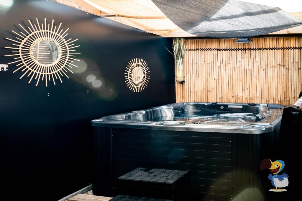 a bathroom with a sink and a mirror on the wall at L'intemporelle - Piscine et Spa in Le Tampon