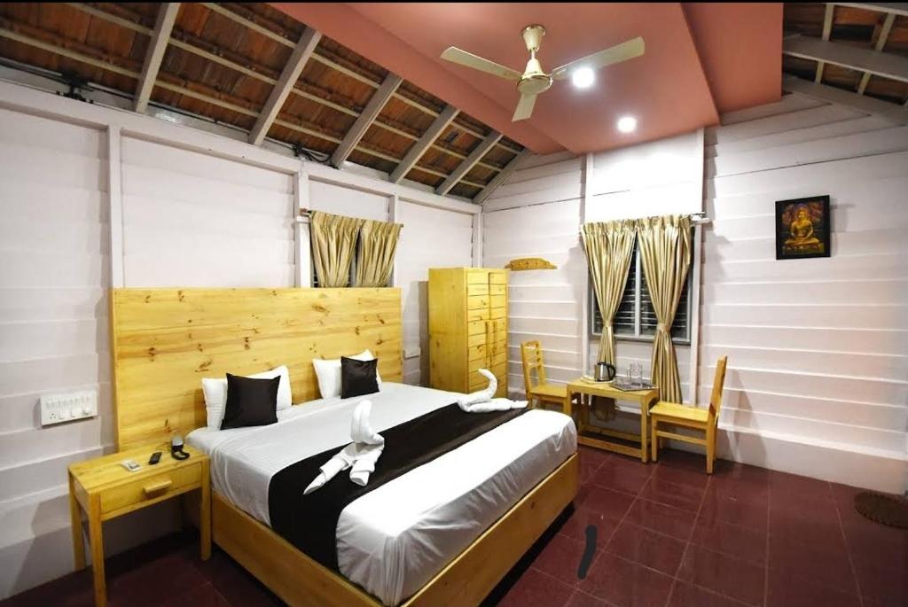 a bedroom with a bed with two birds on it at Kings Mysuru hotels - SGH in Mysore