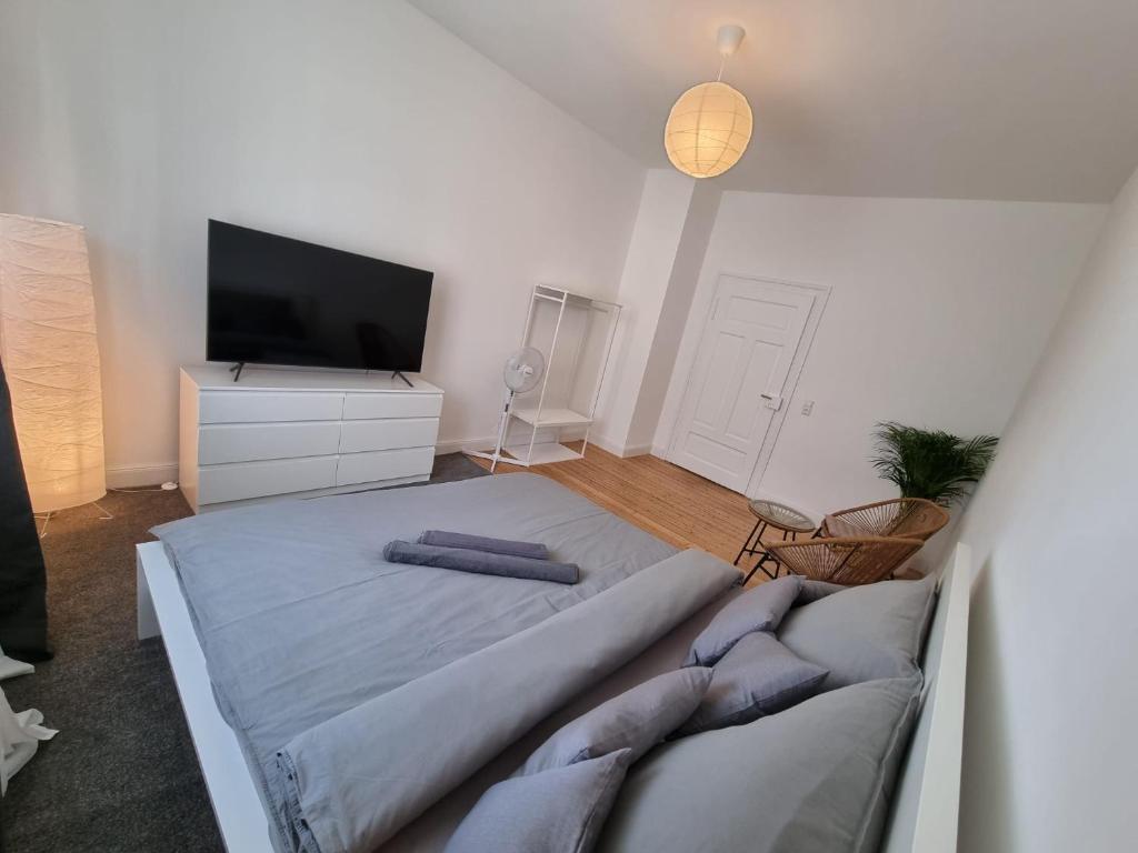 a bedroom with a large bed and a tv at Süße Marie 7 in Karlsruhe