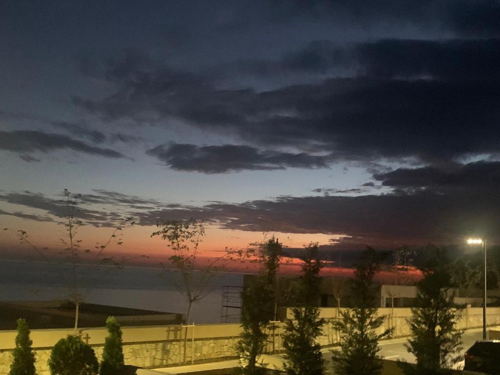 a view of a cloudy sky at sunset at Green Coast Palase in Palasë