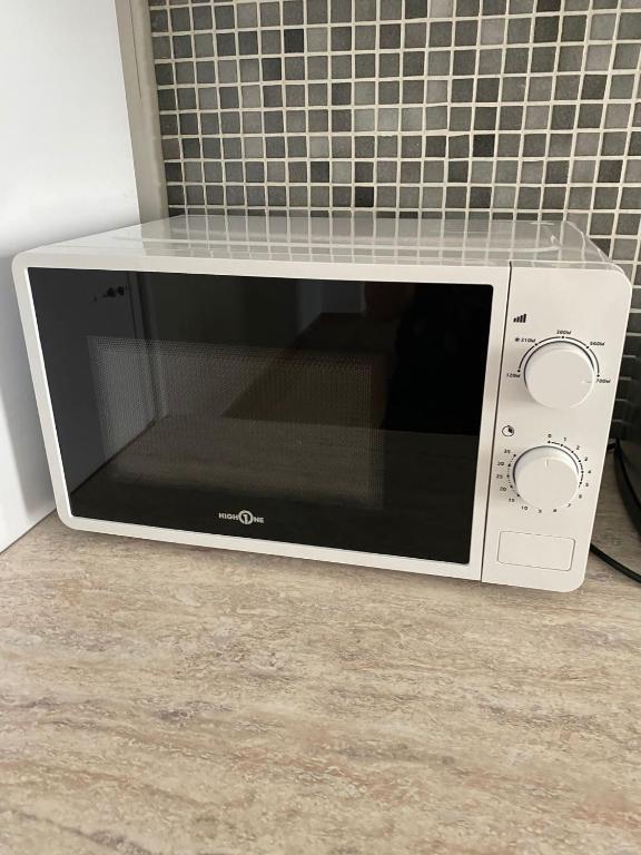 a microwave oven sitting on top of a counter at L&#39;Harmonie de Wavre in Wavre