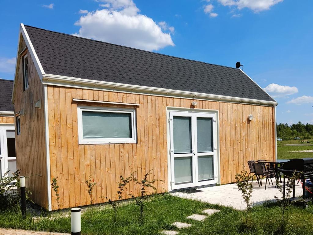 un abri en bois avec une table et un patio dans l'établissement ZAGAJNIK Country Camp obok Suntago, à Grabce