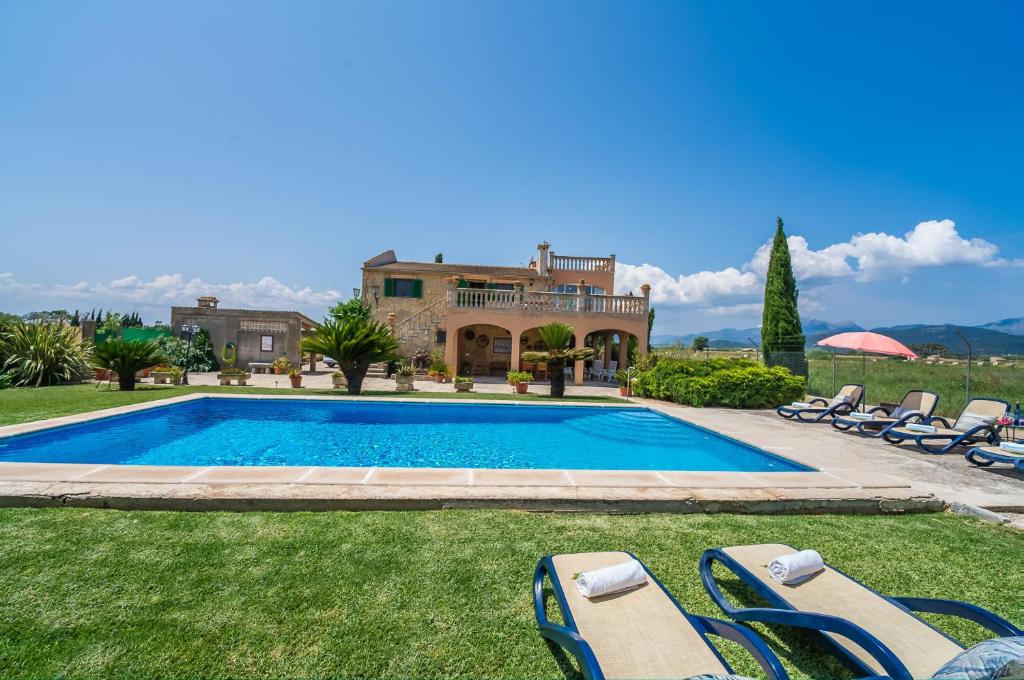 a villa with a swimming pool in front of a house at Ideal Property Mallorca - Villa Gomila in Sa Pobla
