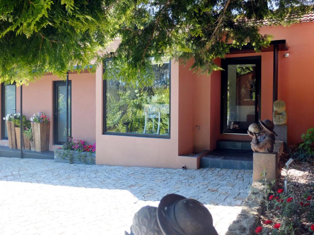 Uma casa com uma estátua de um urso de peluche à frente. em Family Secrets Douro em Riba Douro