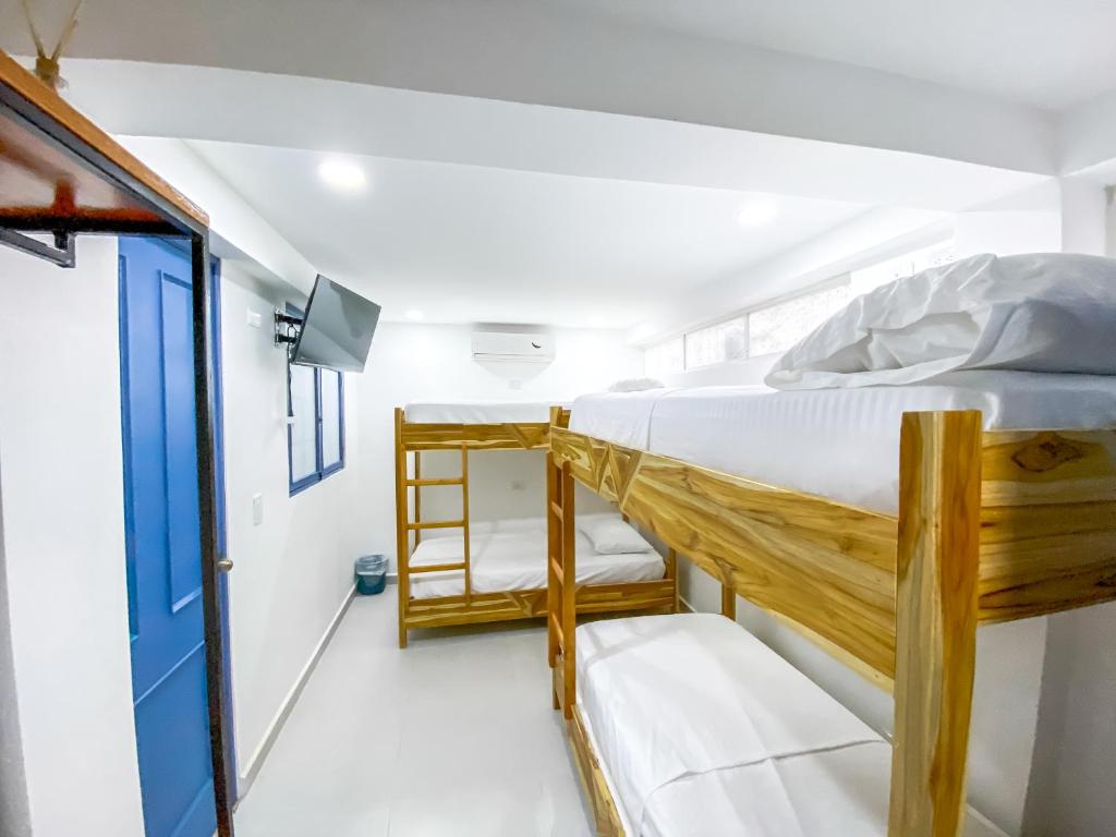 a room with two bunk beds and a ladder at Casa Liz Hotel Boutique in Santa Marta