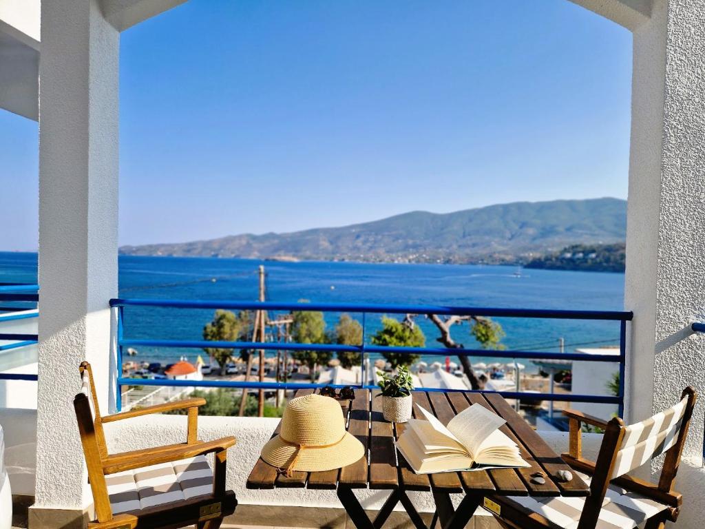 a patio with a table with a view of the ocean at Christine Studios in Poros
