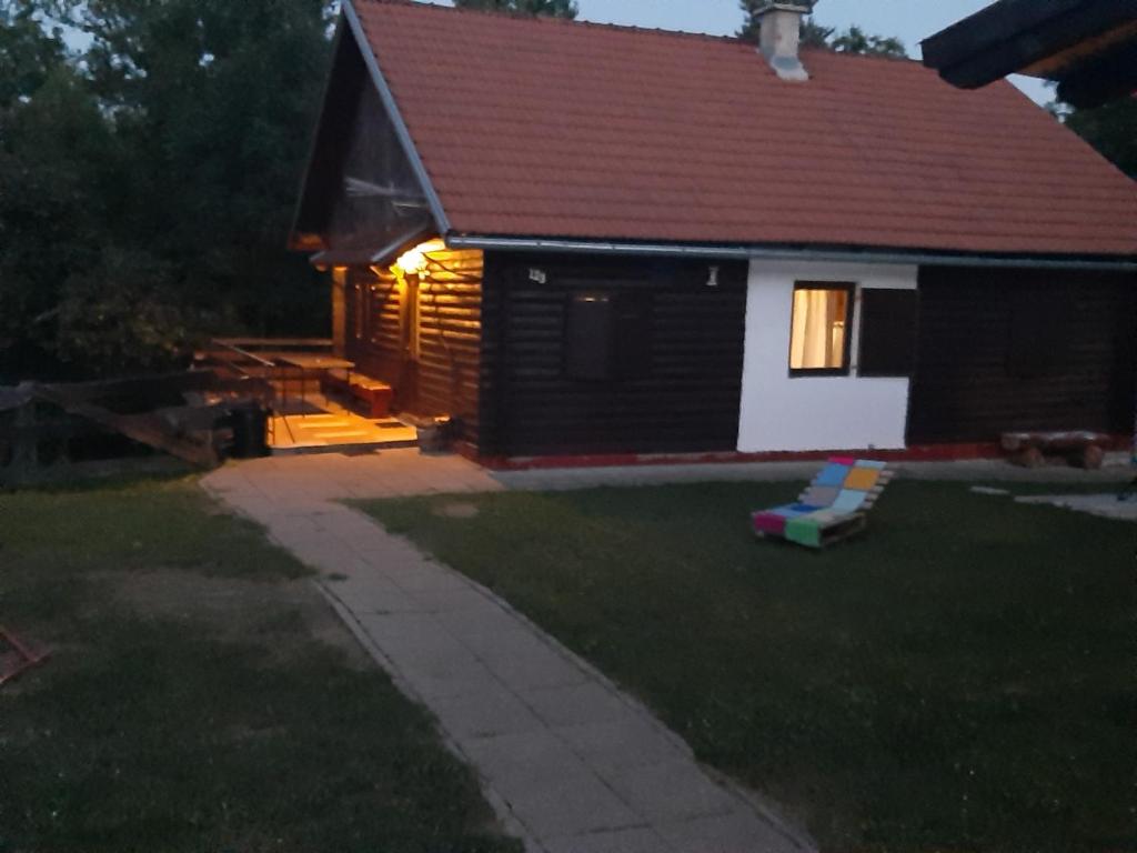 a house with a light on in the yard at Ranch Farm Stay in Rakovica