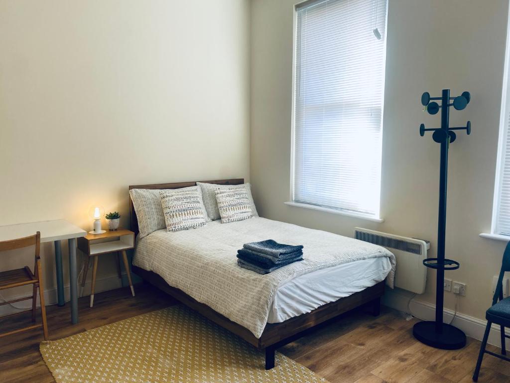 a bedroom with a bed with a cross on the wall at HAGGERSTON in London