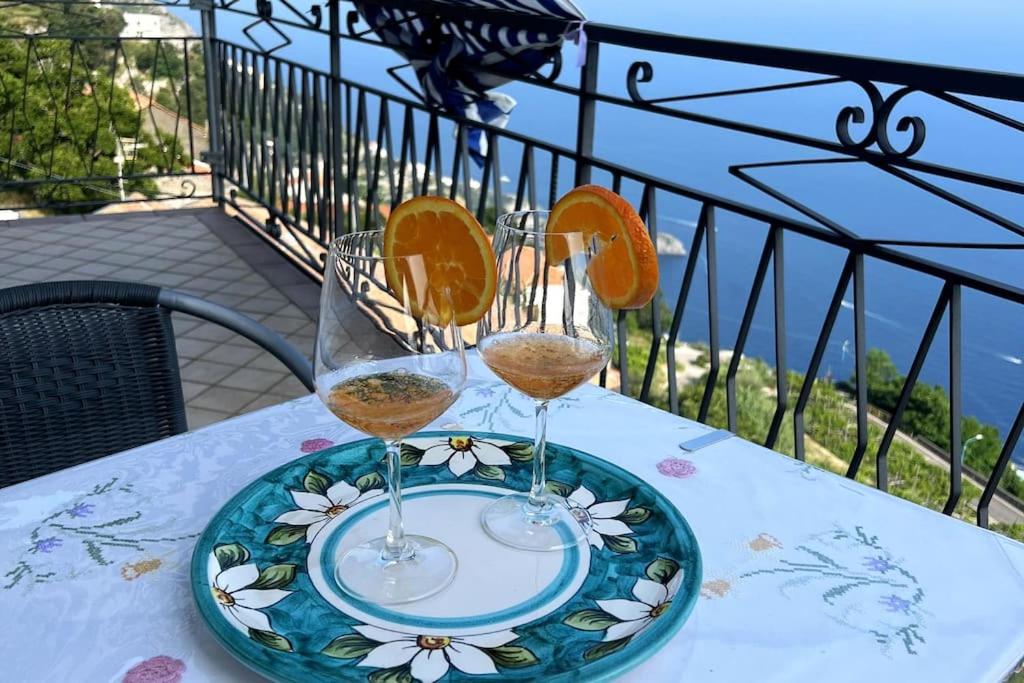a plate with two glasses of wine on a table at Furore house of Benedetta in Furore