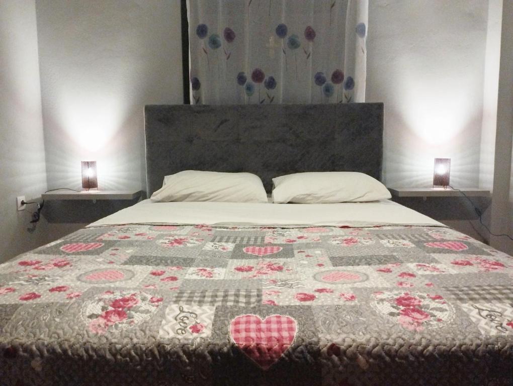 a bedroom with a bed with a quilt on it at Luxury Apartment in Dhamoulianáta