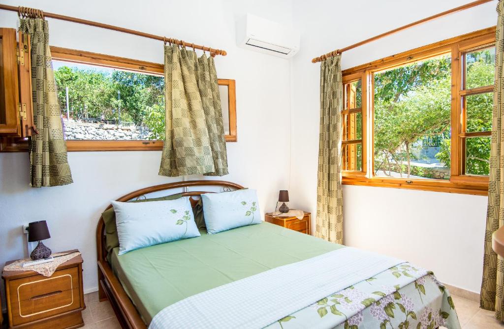 a bedroom with a bed and a window at Tzatzaminia Cottage in Argostoli