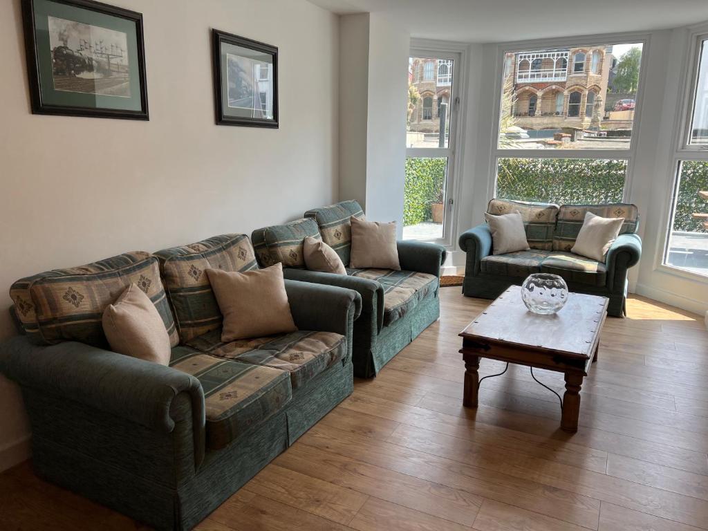 a living room with two couches and a coffee table at Beautiful Apartment,no 1, With Parking in Ilfracombe