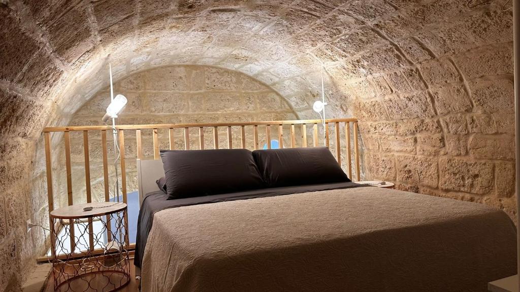 a bedroom with a bed in a brick tunnel at Murat48 in Bari