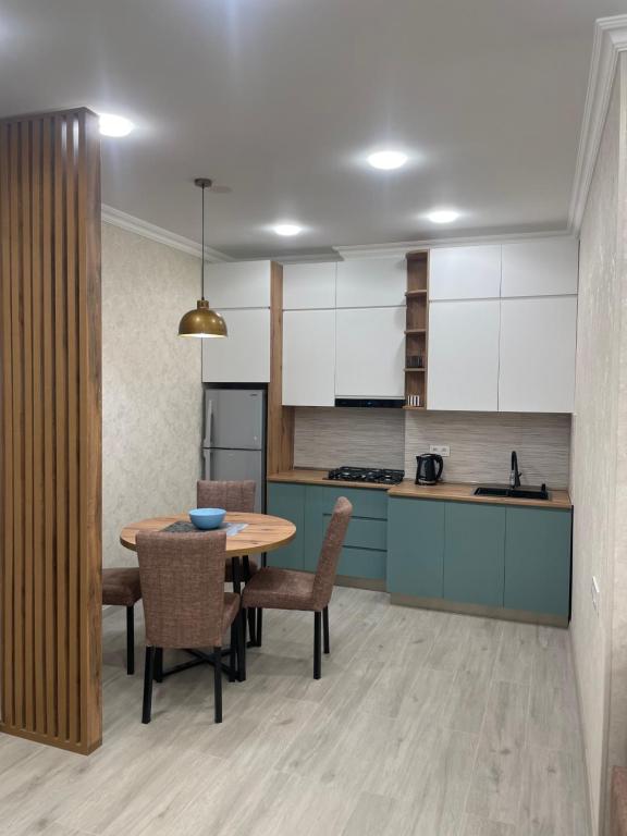 a kitchen and dining room with a table and chairs at Sano's Home in Kutaisi