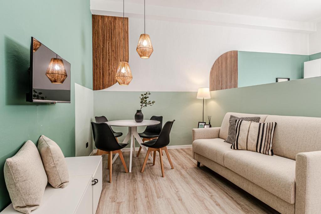 a living room with a couch and a table at Japandi, Appartamento Zona Porto Mediceo Livorno in Livorno