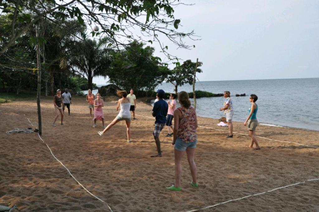 a group of people playing a game on the beach at Banda Island Resort and Campsite in Kalangala