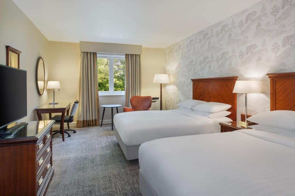 a hotel room with two beds and a flat screen tv at Delta Hotels by Marriott Preston in Preston