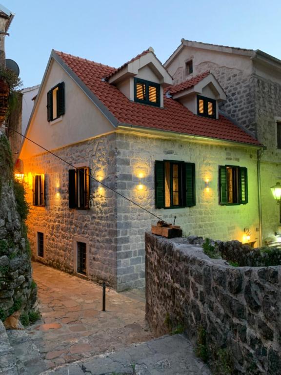 a large stone house with lights on it at KAŽIN supreme in Kotor