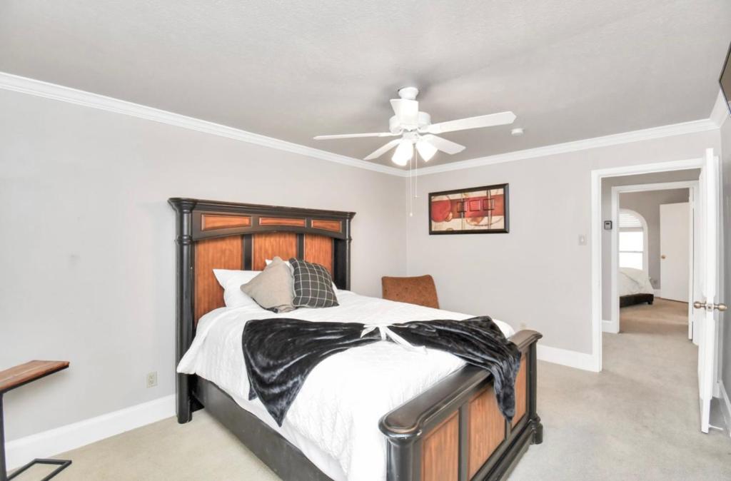 a bedroom with a bed and a ceiling fan at Contemporary Master Queen Suite in Houston