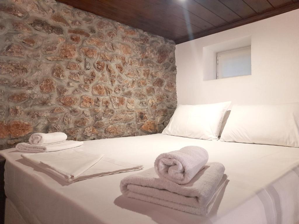 a bedroom with a bed with towels on it at Ζoe Studios in Kýthira