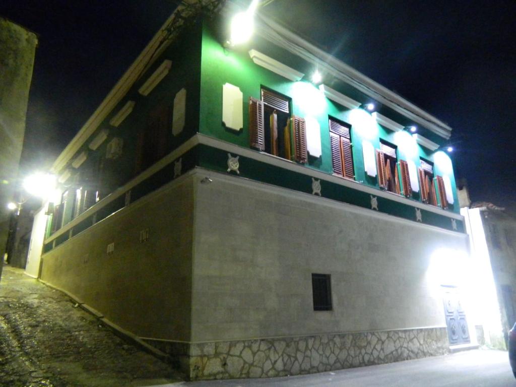 a building with green lights on top of it at night at Vienna Story Guesthouse in Mostar