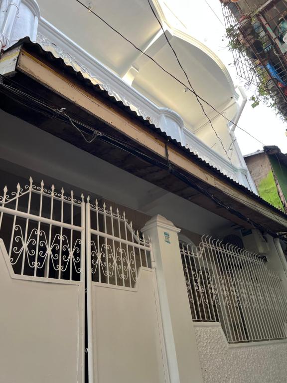 a white garage door with a balcony on a house at RJ Apartment in Catbalogan