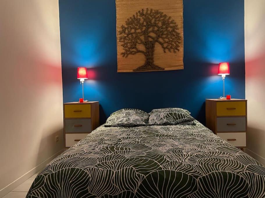 une chambre avec un lit avec deux commodes et deux lampes dans l'établissement Chez Georges, à Sète