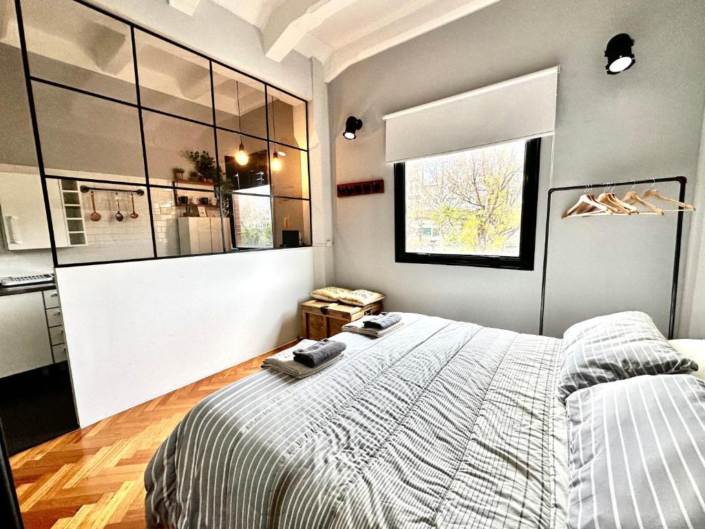a bedroom with a large bed and a window at Madero Apartment in Buenos Aires