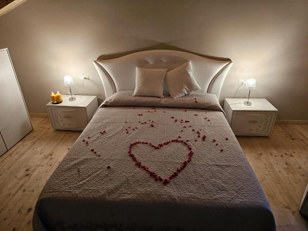 a bedroom with a bed with a heart on it at Il Rifugio Del Certosino in Padula