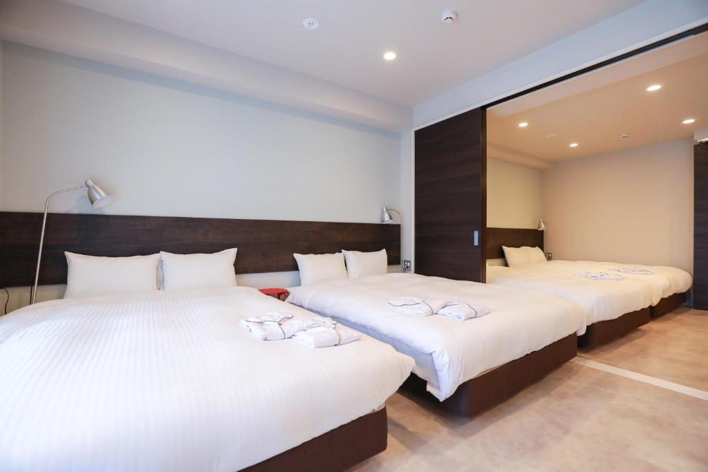 Postel nebo postele na pokoji v ubytování HOTEL so SUMIYOSHI