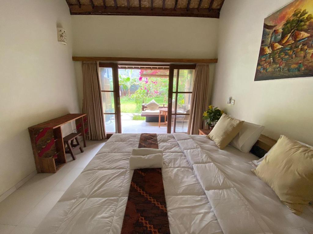 Postel nebo postele na pokoji v ubytování Pomelo Guest House