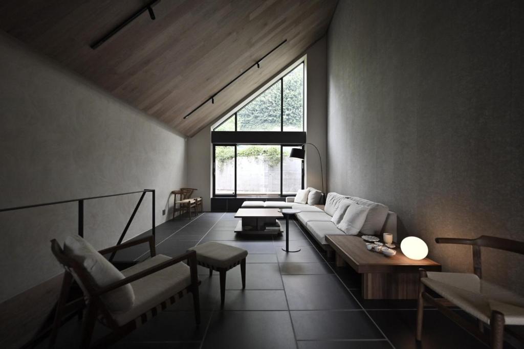 a living room with a couch and a window at Kakurega Tokyo villa in Tokyo