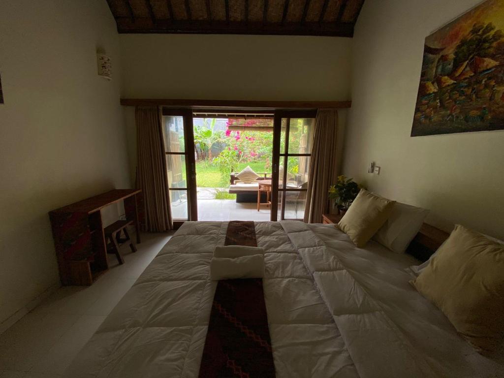 Postel nebo postele na pokoji v ubytování Pomelo Guest House