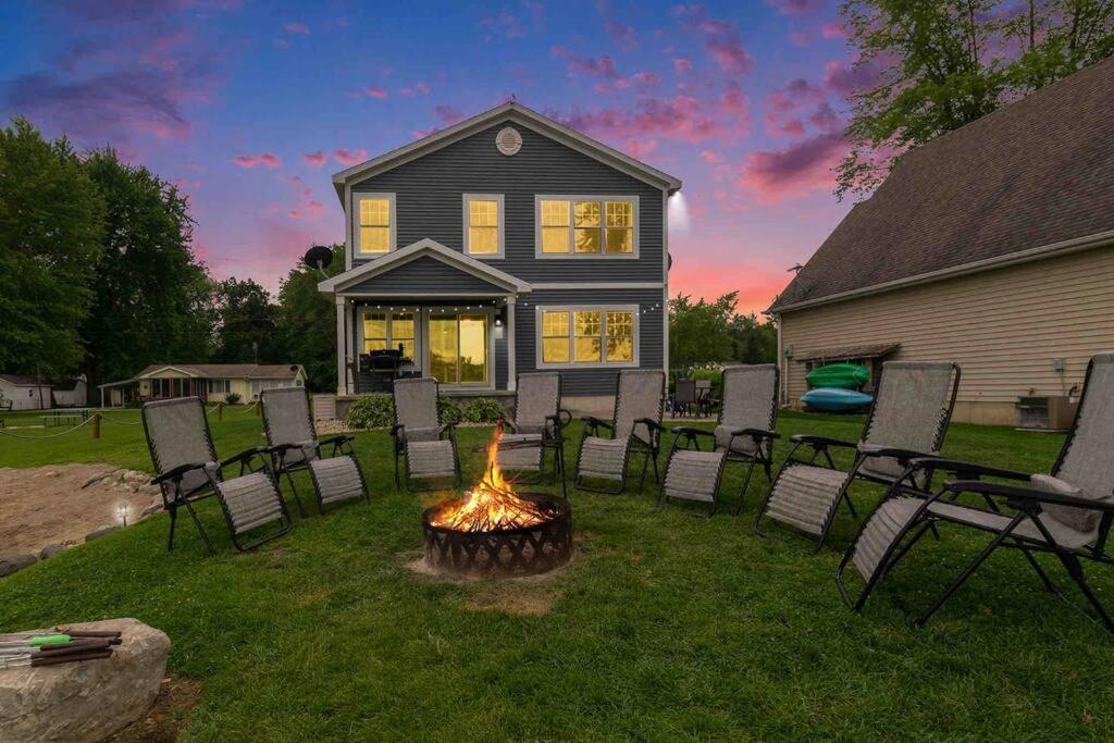 a group of chairs around a fire pit in a yard at The Heron House-On The Lake! in Wolcottville