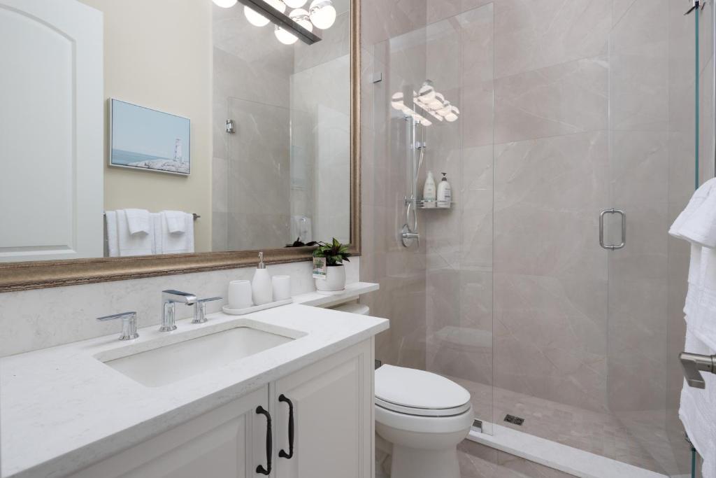 a bathroom with a sink and a toilet and a shower at Vancouver Vacation Home in Richmond