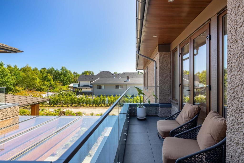 a balcony with couches on a house at Vancouver Vacation Home in Richmond