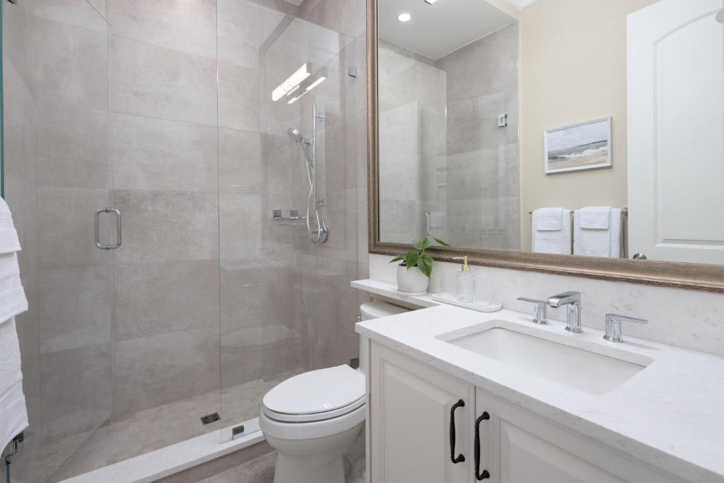 a bathroom with a toilet and a sink and a shower at Vancouver Vacation Home in Richmond