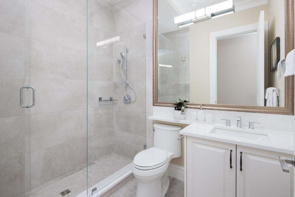 a bathroom with a shower and a toilet and a sink at Vancouver Vacation Home in Richmond