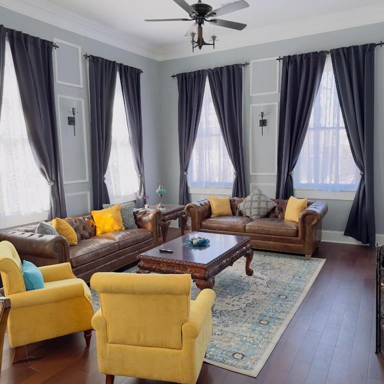 a living room with couches and a coffee table at The Historic Bourbon Suit walk to French Quarter in New Orleans
